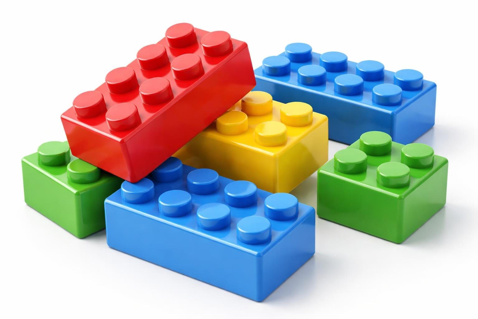 Blocos de montar coloridos dispostos de forma organizada sobre uma superfície branca.